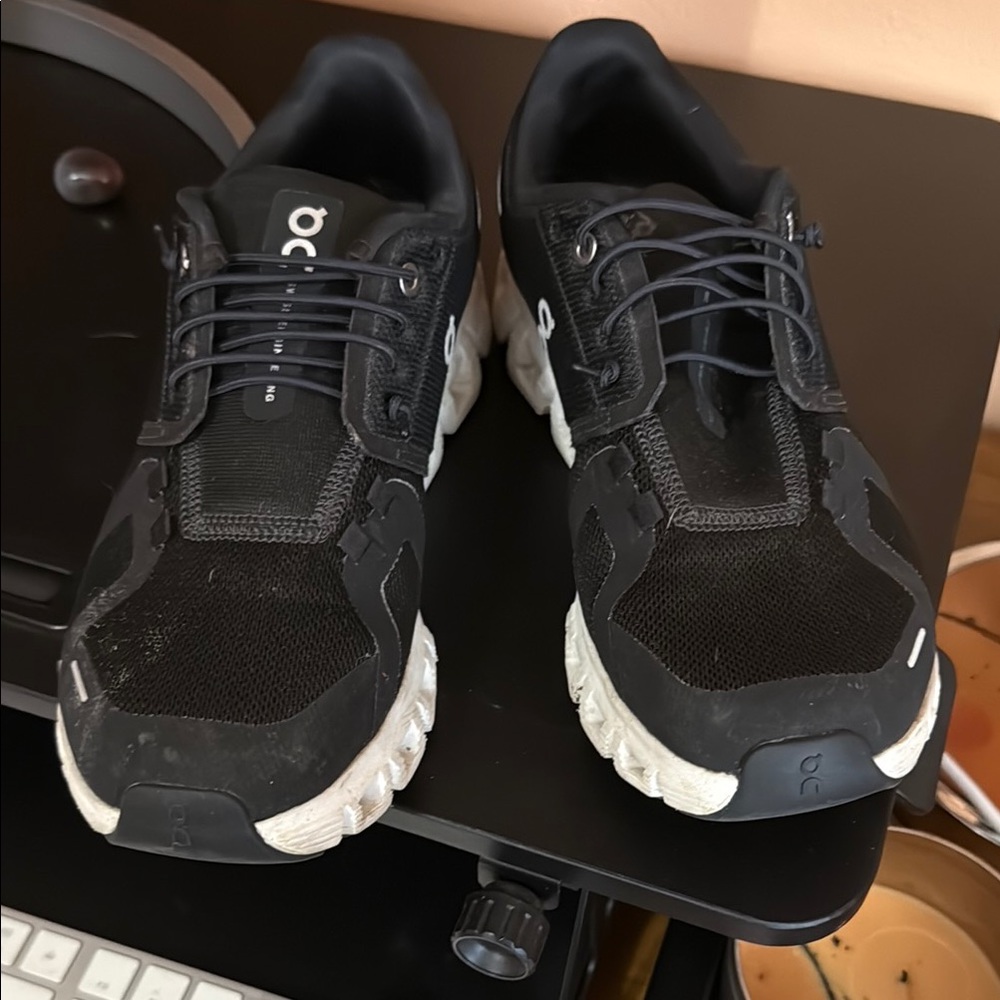 On Running Black and White Athletic Shoes with Cushioned Sole gently worn